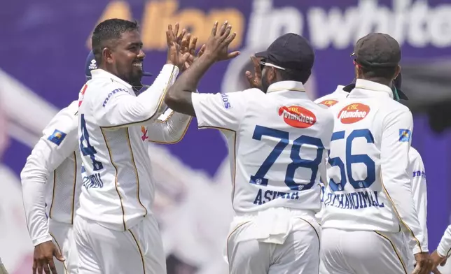 Sri Lanka's Tharindu Ratnayake, left, celebrates the wicket of Bangladesh's Shadman Islam with teammates during the first day of the first cricket test match between Sri Lanka and Bangladesh in Galle, Sri Lanka, Tuesday, June 17, 2025. (AP Photo/Eranga Jayawardena)