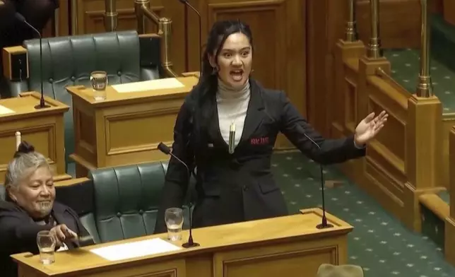 This image from May 15, 2025 video shows New Zealand lawmaker Hana-Rāwhiti Maipi-Clarke performing a Māori haka to protest a proposed law in Parliament, in Wellington, New Zealand, (New Zealand Parliament TV via AP)