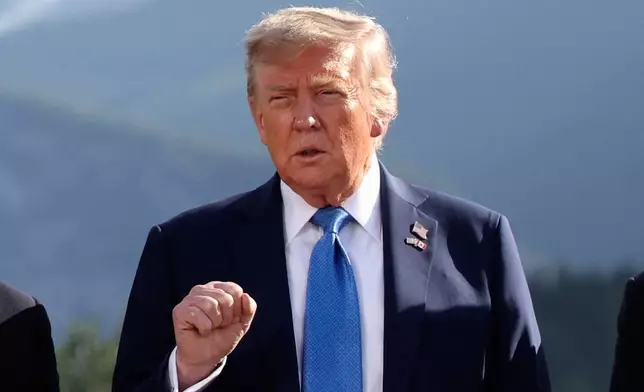 U.S. President Donald Trump gestures as he attends a family photo session during the G7 Summit, in Kananaskis, Alberta, Monday, June 16, 2025. (Suzanne Plunkett/Pool Photo via AP)
