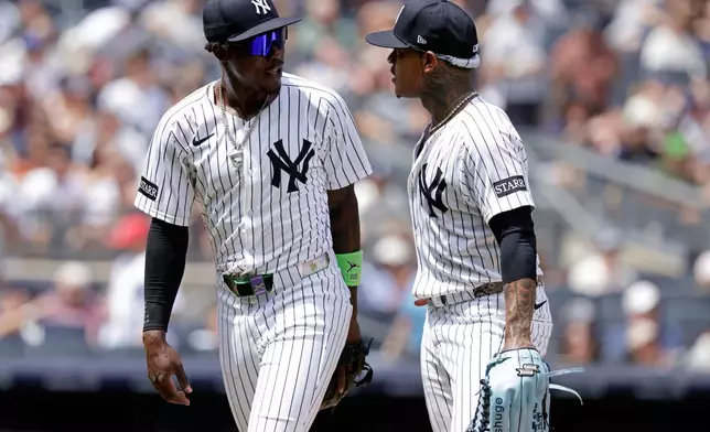 New York Yankees' Jazz Chisholm Jr. and Marcus Stroman, right, react during the third inning of a baseball game against the Athletics, Sunday, June 29, 2025, in New York. (AP Photo/Adam Hunger)