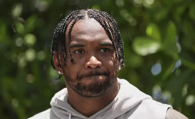 Miami Dolphins quarterback Tua Tagovailoa speaks to the press after a practice at NFL football minicamp, Tuesday, June 10, 2025, in Miami Gardens, Fla. (AP Photo/Rebecca Blackwell)