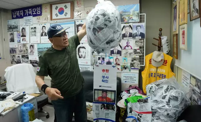 South Korean Choi Sung-Yong, a head of the Abductee's Family Union, holds a plastic bag containing leaflets during an interview with The Associated Press at his office in Seoul, South Korea, on June 14, 2025. (AP Photo/Ahn Young-joon)
