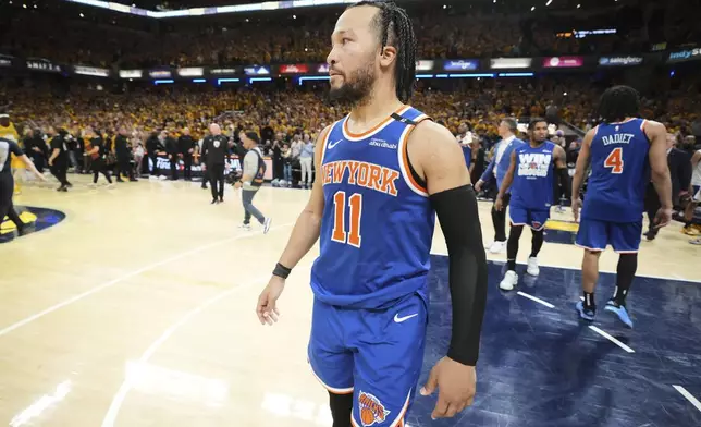 New York Knicks guard Jalen Brunson (11) reacts after losing to the Indiana Pacers in Game 6 of the Eastern Conference finals of the NBA basketball playoffs in Indianapolis, Saturday, May 31, 2025. (AP Photo/Michael Conroy)