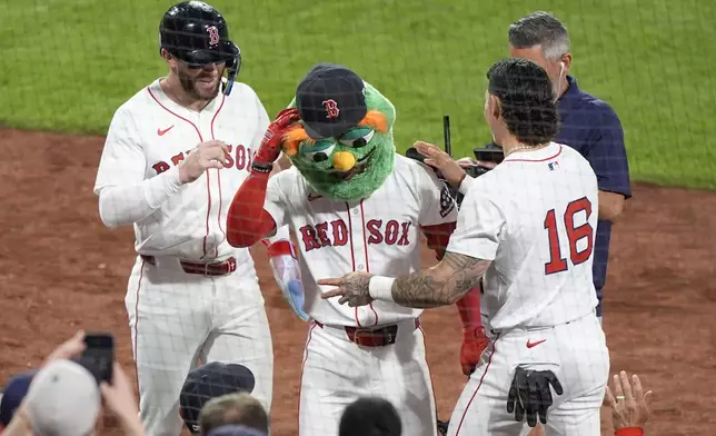 Boston Red Sox's Ceddanne Rafaela, center, celebrates his two-run homer in the sixth inning of a baseball game against the Los Angeles Angels, Tuesday, June 3, 2025, in Boston. (AP Photo/Robert F. Bukaty)