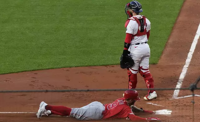 Los Angeles Angels' Zach Neto slides home on a hit by Nolan Schanuel in the third inning of a baseball game against the Boston Red Sox, Tuesday June 3, 2025, in Boston. (AP Photo/Robert F. Bukaty)