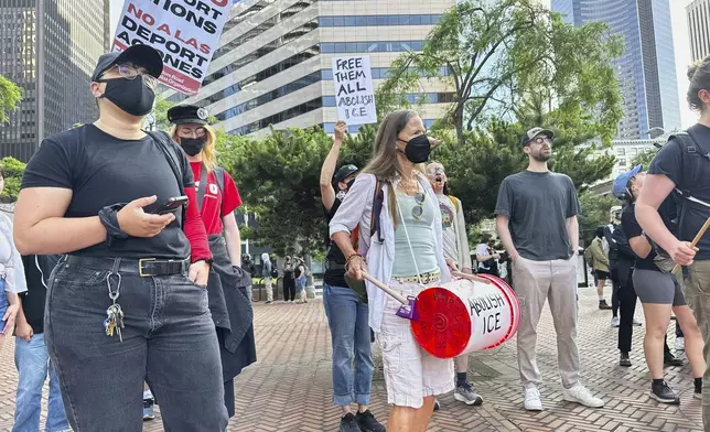 People gather outside immigration court in downtown Seattle on Tuesday, June 10, 2025, chanting with drums and holding up signs reading, “Free Them All Abolish ICE,” and “No to Deportations,” in solidarity with the protesters in Los Angeles voicing opposition to ICE arrests. (AP Photo/Martha Bellisle)