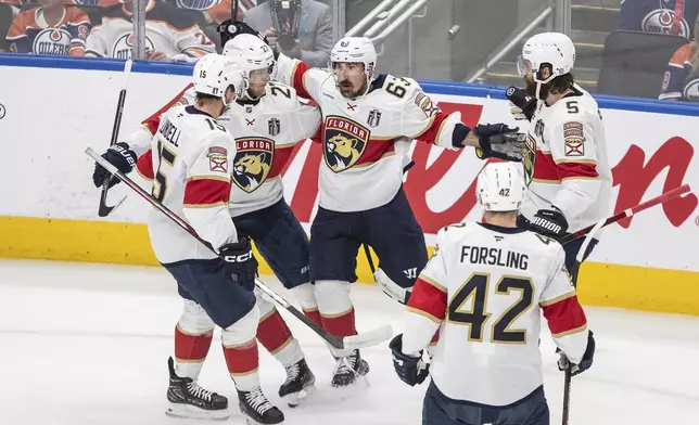 Florida Panthers centerBrad Marchand (63) celebrates with teammates after his goal against the Edmonton Oilers during the first period in Game 5 of the NHL hockey Stanley Cup Final in Edmonton, Alberta, Saturday, June 14, 2025. (Jason Franson/The Canadian Press via AP)