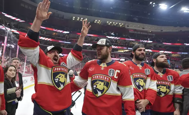 Florida Panthers center Brad Marchand and captain Aleksander Barkov celebrate after defeating the Edmonton Oilers in Game 6 of the NHL hockey Stanley Cup Final Tuesday, June 17, 2025, in Sunrise, Fla. (AP Photo/Lynne Sladky)