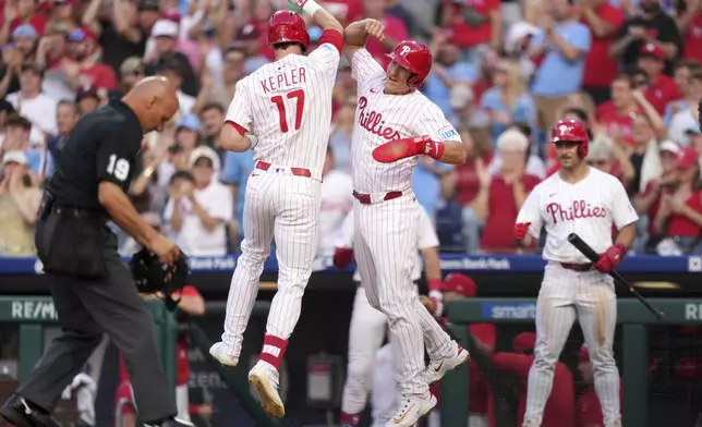 Philadelphia Phillies' Max Kepler, left, and J.T. Realmuto celebrate after Kepler's two-run home run during the second inning of a baseball game against the Chicago Cubs Tuesday, June 10, 2025, in Philadelphia. (AP Photo/Matt Slocum)