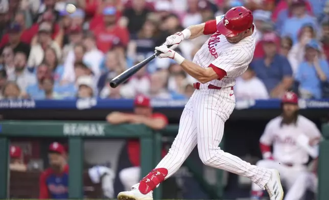 Philadelphia Phillies' Max Kepler, right, hits a two-run home run against Chicago Cubs pitcher Colin Rea during the second inning of a baseball game Tuesday, June 10, 2025, in Philadelphia. (AP Photo/Matt Slocum)
