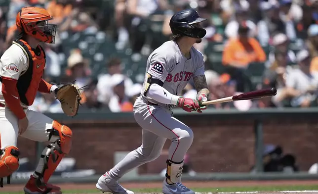 Boston Red Sox's Jarren Duran, right, watches his fly ball that San Francisco Giants left fielder Heliot Ramos made an error on that allowed Roman Anthony to score next to catcher Patrick Bailey, left, during the first inning of a baseball game in San Francisco, Sunday, June 22, 2025. (AP Photo/Jeff Chiu)