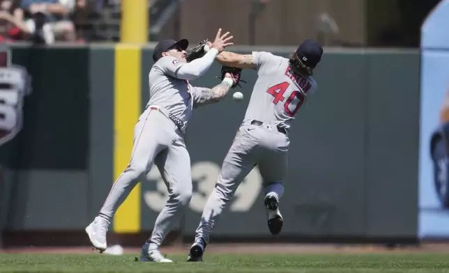 Boston Red Sox third baseman Nate Eaton (40) commits a fielding error next to left fielder Jarren Duran on a fly ball hit by San Francisco Giants' Patrick Bailey during the third inning of a baseball game in San Francisco, Sunday, June 22, 2025. (AP Photo/Jeff Chiu)
