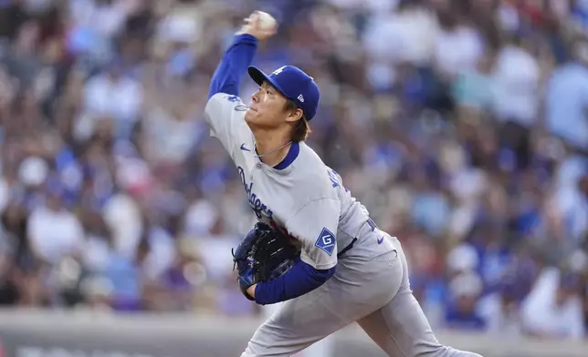 Los Angeles Dodgers starting pitcher Yoshinobu Yamamoto works against the Colorado Rockies in the first inning of a baseball game Wednesday, June 25, 2025, in Denver. (AP Photo/David Zalubowski)