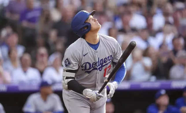 Los Angeles Dodgers' Shohei Ohtani flies out against Colorado Rockies starting pitcher Chase Dollander in the first inning of a baseball game Wednesday, June 25, 2025, in Denver. (AP Photo/David Zalubowski)