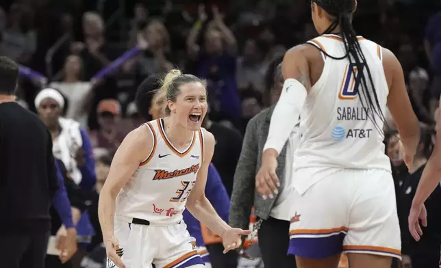 Phoenix Mercury guard Sami Whitcomb (33) celebrates a score against the Golden State Valkyries with Mercury forward Satou Sabally (0) during the second half of a WNBA basketball game Thursday, June 5, 2025, in Phoenix. (AP Photo/Ross D. Franklin)