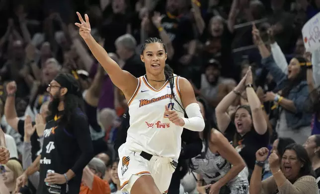 Phoenix Mercury forward Satou Sabally celebrates a 3-pointer by Mercury's Lexi Held during the second half of a WNBA basketball game against the Golden State Valkyries Thursday, June 5, 2025, in Phoenix. (AP Photo/Ross D. Franklin)