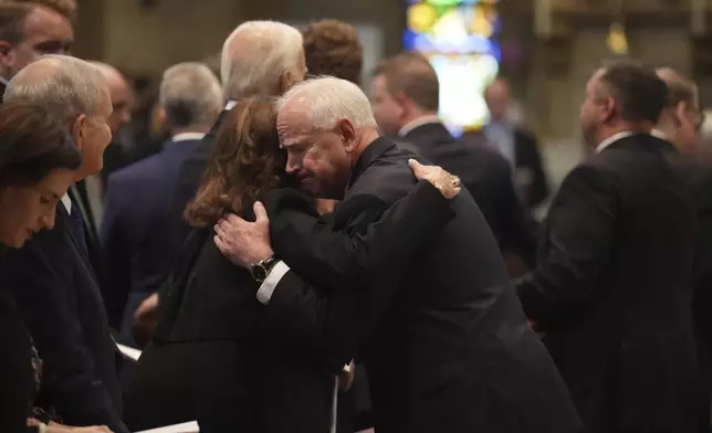 Gov. Tim Walz hugs former US Vice President Kamala Harris before funeral services for Mark and Melissa Hortman at the Basilica of St. Mary in Minneapolis, Minn., on Saturday, June 28, 2025. (Alex Kormann/Star Tribune via AP, Pool)