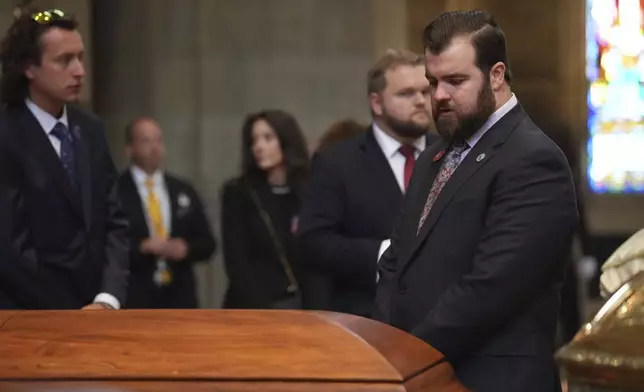 Colin Hortman, son of Melissa and Mark Hortman, views the caskets in the sanctuary of the Basilica of St. Mary before funeral services for Mark and Melissa Hortman in Minneapolis, Minn., on Saturday, June 28, 2025. (Alex Kormann /Star Tribune via AP, Pool)