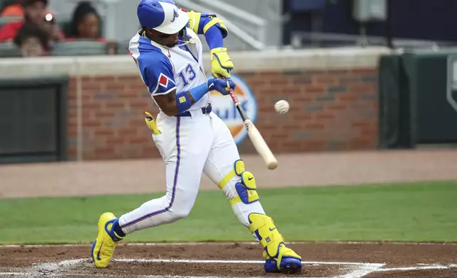 Atlanta Braves' Ronald Acuña Jr. (13) hits a single in the first inning of a baseball game against the Philadelphia Phillies, Saturday, June 28, 2025, in Atlanta. (AP Photo/Colin Hubbard)