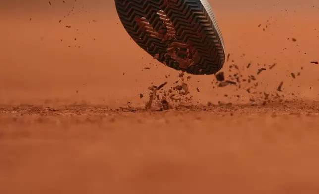 Kazakhstan's Alexander Bublik kicks the clay as he serves against Italy's Jannik Sinner during their quarterfinal match of the French Tennis Open at the Roland-Garros stadium in Paris, Wednesday, June 4, 2025. (AP Photo/Lindsey Wasson)