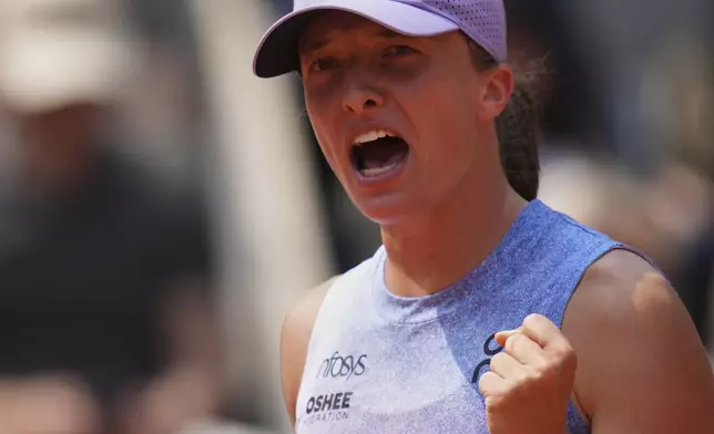 Poland's Iga Swiatek celebrates as she won the quarterfinal match of the French Tennis Open against Ukraine's Elina Svitolina at the Roland-Garros stadium in Paris, Tuesday, June 3, 2025. (AP Photo/Christophe Ena)