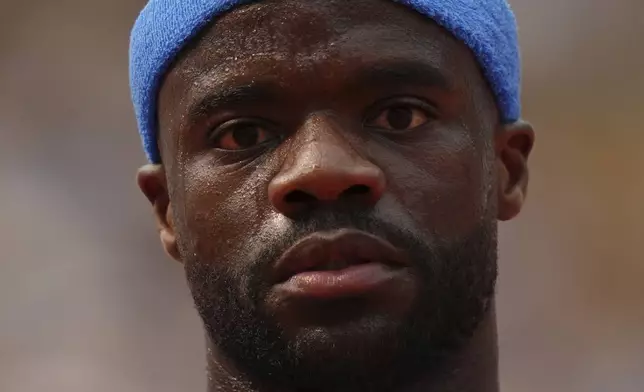 Frances Tiafoe of the U.S. reacts as he plays against Italy's Lorenzo Musetti during their quarterfinal match of the French Tennis Open at the Roland-Garros stadium in Paris, Tuesday, June 3, 2025. (AP Photo/Aurelien Morissard)