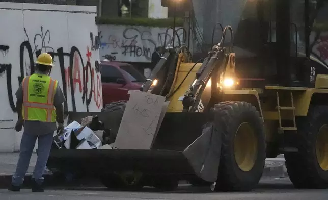Cleanup continues after a night of protests in downtown Los Angeles, Tuesday, June 10, 2025. (AP Photo Damian Dovarganes)