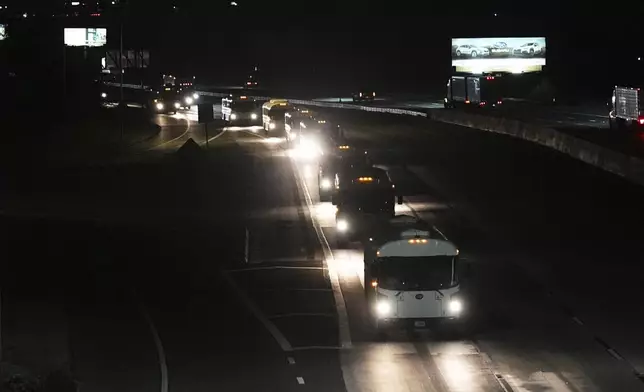 A convoy of buses moves along Interstate Highway 10 after leaving the Marine Corps base in Twentynine Palms, Calif, Monday, June 9, 2025, near Redlands, Calif. (AP Photo/Gregory Bull)