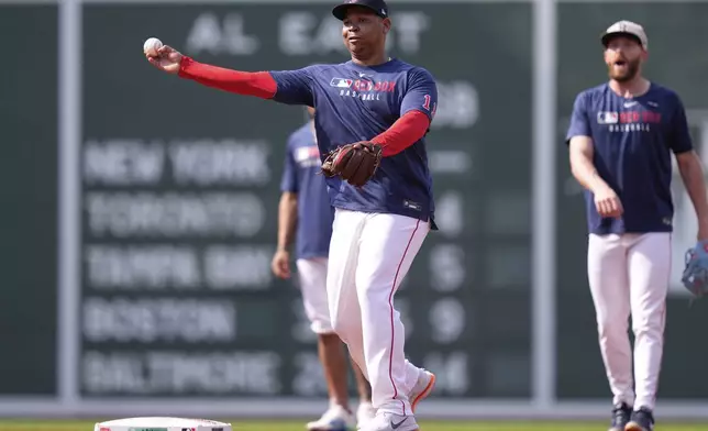 Boston Red Sox designated hitter Rafael Devers, center, takes infield practice with teammates prior to a baseball game against the Tampa Bay Rays at Fenway Park, Wednesday, June 11, 2025, in Boston. (AP Photo/Charles Krupa)