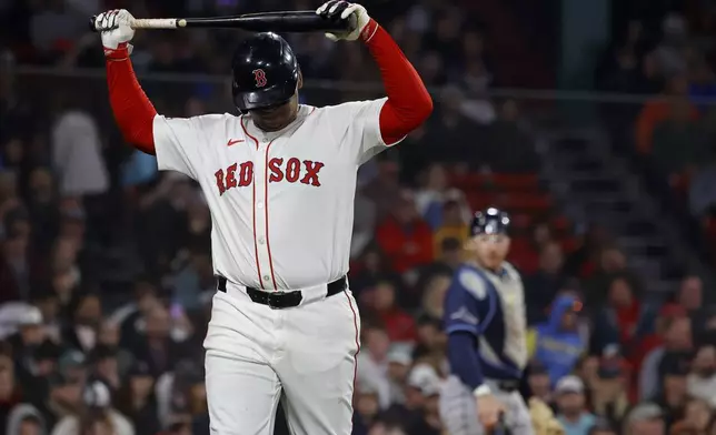Boston Red Sox designated hitter Rafael Devers reacts after striking out as Tampa Bay Rays catcher Danny Jansen looks on during the seventh inning of a baseball game at Fenway Park, Monday, June 9, 2025, in Boston. (AP Photo/Mary Schwalm)
