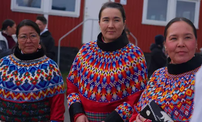Locals wearing a traditional clothing made of pearl collar and seal hides participating the National Day in Nuuk, Greenland (AP Photo/Kwiyeon Ha)
