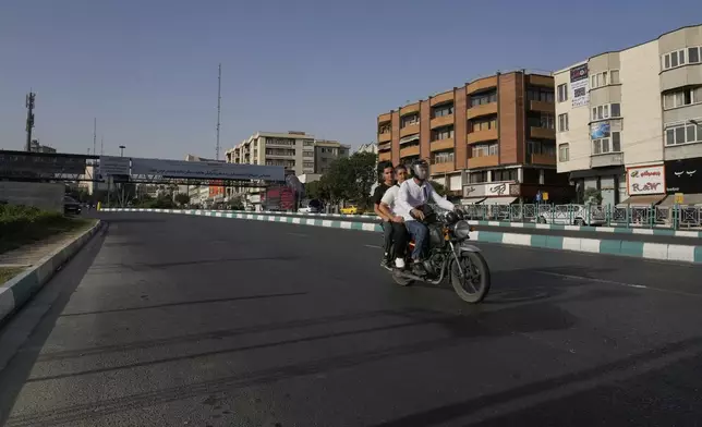 A motorbike drives in a quiet square in downtown Tehran, Iran, Monday, June 23, 2025. (AP Photo/Vahid Salemi)