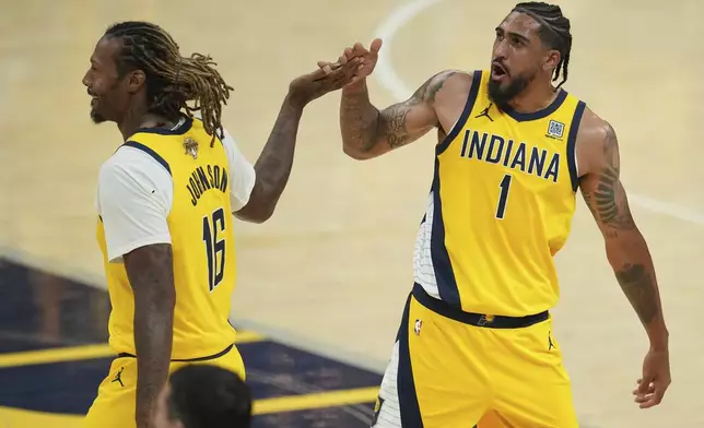 Indiana Pacers forward Obi Toppin (1) celebrates with forward James Johnson (16) during the second half of Game 6 of the NBA Finals basketball series against the Oklahoma City Thunder, Thursday, June 19, 2025, in Indianapolis. (AP Photo/Michael Conroy)