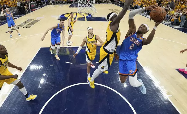 Oklahoma City Thunder guard Shai Gilgeous-Alexander (2) drives to the basket against Indiana Pacers forward Pascal Siakam (43) during the second half during the first half of Game 6 of the NBA Finals basketball series, Thursday, June 19, 2025, in Oklahoma City. (Kyle Terada/Pool Photo via AP)