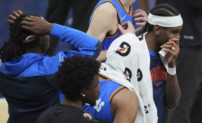 Oklahoma City Thunder guard Shai Gilgeous-Alexander, right, stands with teammates during a timeout during the second half of Game 6 of the NBA Finals basketball series against the Indiana Pacers, Thursday, June 19, 2025, in Indianapolis. (AP Photo/Michael Conroy)