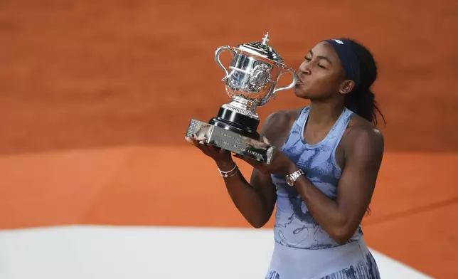 Coco Gauff of the U.S. kisses the trophy after winning the final match of the French Tennis Open against Aryna Sabalenka of Belarus at the Roland-Garros stadium in Paris, Saturday, June 7, 2025. (AP Photo/Lindsey Wasson)