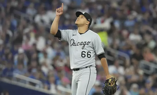 Chicago White Sox pitcher Wikelman Gonzalez reacts as he walks back to the dugout after making his debut during seventh-inning baseball game action against the Toronto Blue Jays in Toronto, Friday June 20, 2025. (Chris Young/The Canadian Press via AP)