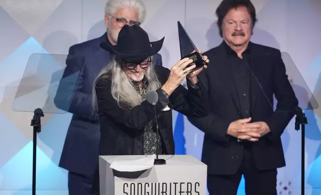 Michael McDonald, from left, Patrick Simmons, and Tom Johnston of The Doobie Brothers accept an award during the 54th annual Songwriters Hall of Fame induction and awards gala on Thursday, June 12, 2025, at the Marriott Marquis Hotel in New York. (Photo by Charles Sykes/Invision/AP)