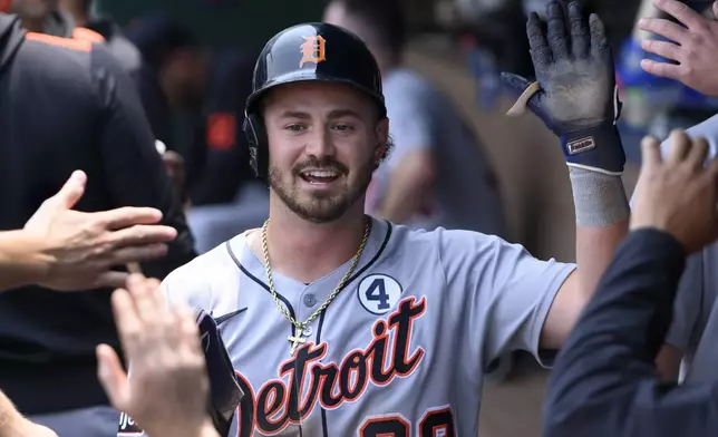 Detroit Tigers' Zach McKinstry is congratulated after scoring on a wild pitch during the third inning of a baseball game against the Kansas City Royals in Kansas City, Mo., Sunday, June 1, 2025. (AP Photo/Reed Hoffmann)