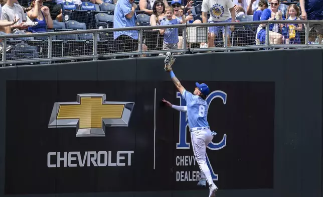 Kansas City Royals left fielder Drew Waters cannot catch a foul ball off the bat of Detroit Tigers' Javier Baez during the seventh inning of a baseball game in Kansas City, Mo., Sunday, June 1, 2025. (AP Photo/Reed Hoffmann)
