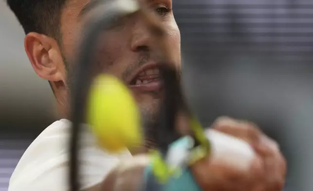 Spain's Carlos Alcaraz plays a shot against Tommy Paul of the U.S. during their quarterfinal match of the French Tennis Open at the Roland-Garros stadium in Paris, Tuesday, June 3, 2025. (AP Photo/Thibault Camus)