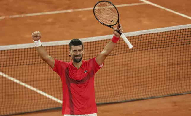 Serbia's Novak Djokovic celebrates as he won the quarterfinal match of the French Tennis Open against Germany's Alexander Zverev at the Roland-Garros stadium in Paris, Wednesday, June 4, 2025. (AP Photo/Aurelien Morissard)