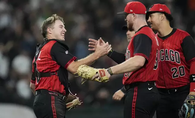 Chicago White Sox catcher Kyle Teel (8), left, and first baseman Tim Elko (30) celebrate their team's win over the Kansas City Royals in a baseball game Friday, June 6, 2025, in Chicago. (AP Photo/Erin Hooley)