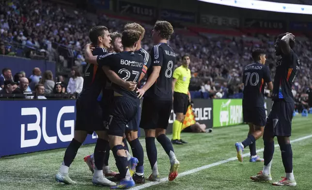 San Diego FC's Milan Iloski, left, celebrates his third goal against the Vancouver Whitecaps during the first half of an MLS soccer match in Vancouver, British Columbia, Wednesday, June 25, 2025. (Darryl Dyck/The Canadian Press via AP)