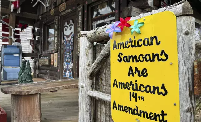 A sign supporting citizenship for American Samoans is posted outside the Log Cabin Gifts store on the waterfront in Whittier, Alaska, May 13, 2025. (AP Photo/Mark Thiessen)
