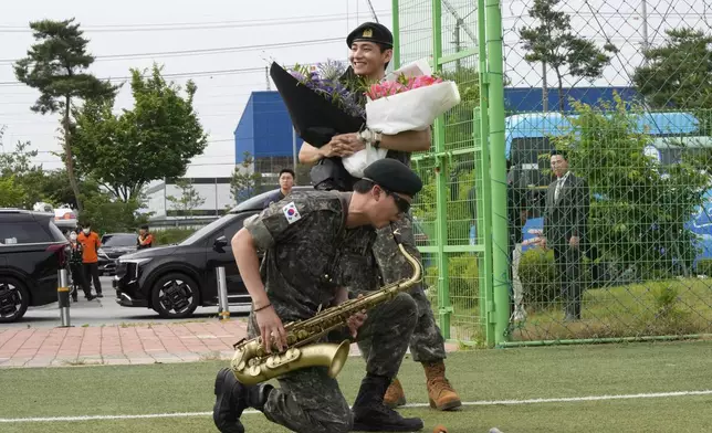 FILE - K-pop band BTS members RM, bottom, and V react after being discharged from a mandatory military service in Chuncheon, South Korea, Tuesday, June 10, 2025. (AP Photo/Ahn Young-joon, File)