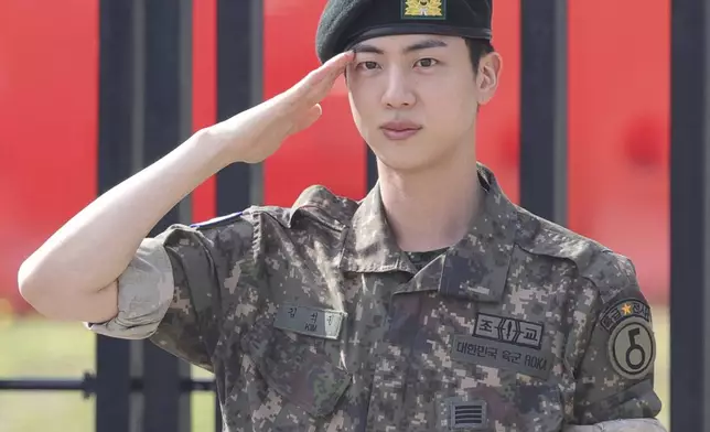 FILE - K-pop band BTS's member Jin salutes after being discharged from a mandatory military service outside of an army base in Yeoncheon, South Korea, Wednesday, June 12, 2024. (Im Byung-shik/Yonhap via AP, File)