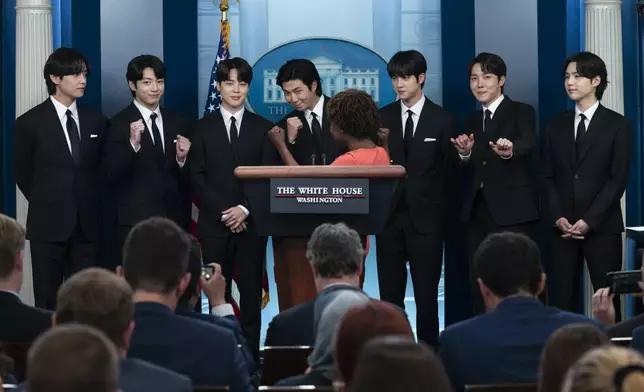 FILE - Members of the K-pop supergroup BTS from left, V, Jungkook, Jimin, RM, Jin, J-Hope, and Suga join White House press secretary Karine Jean-Pierre during the daily briefing at the White House, Tuesday, May 31, 2022, in Washington. (AP Photo/Evan Vucci, File)