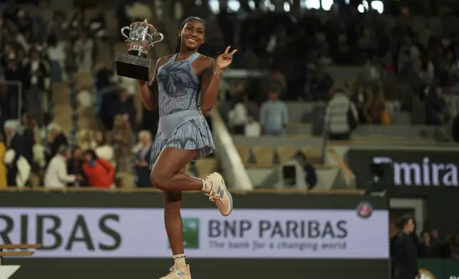 Coco Gauff of the U.S. celebrates with the trophy as she won the final match of the French Tennis Open against Aryna Sabalenka of Belarus at the Roland-Garros stadium in Paris, Saturday, June 7, 2025. (AP Photo/Aurelien Morissard)