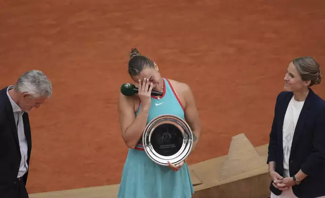 Second placed Aryna Sabalenka of Belarus reacts with her trophy after the final match of the French Tennis Open against winner Coco Gauff of the U.S. at the Roland-Garros stadium in Paris, Saturday, June 7, 2025. (AP Photo/Christophe Ena)
